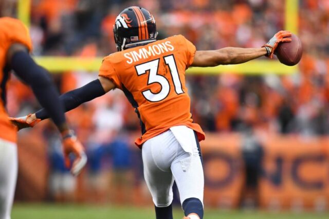 Denver Broncos strong safety Justin Simmons (31) reacts following his interception in the fourth quarter against the Oakland Raiders at Sports Authority Field at Mile High.