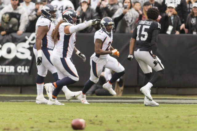 Oakland Raiders wide receiver Michael Crabtree (15) taunts Denver Broncos cornerback Aqib Talib (21) after the incident on the sidelines during the first quarter at Oakland Coliseum.