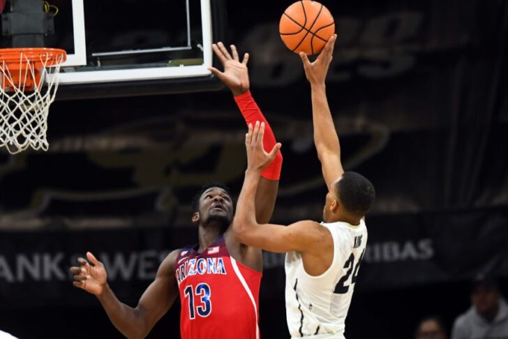 Colorado Buffaloes guard George King (24) attempts a basket over Arizona Wildcats forward Deandre Ayton (13) in the second half at the Coors Events Center.