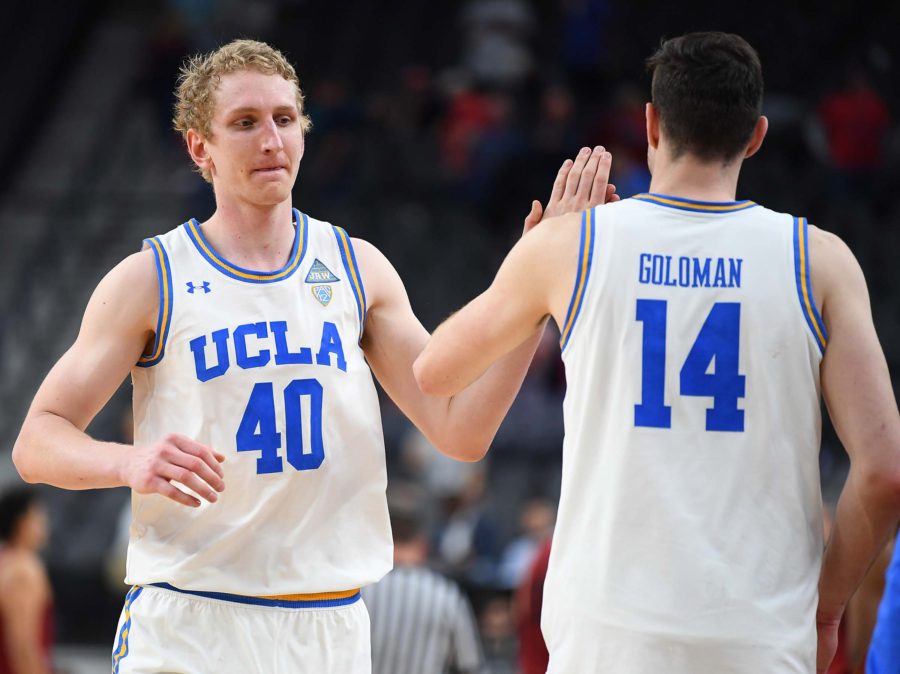 UCLA Bruins center Thomas Welsh (40) celebrates with UCLA Bruins forward Gyorgy Goloman (14) after the Bruins defeated the Stanford Cardinal in a quarterfinal match of the Pac-12 Tournament at T-Mobile Arena.