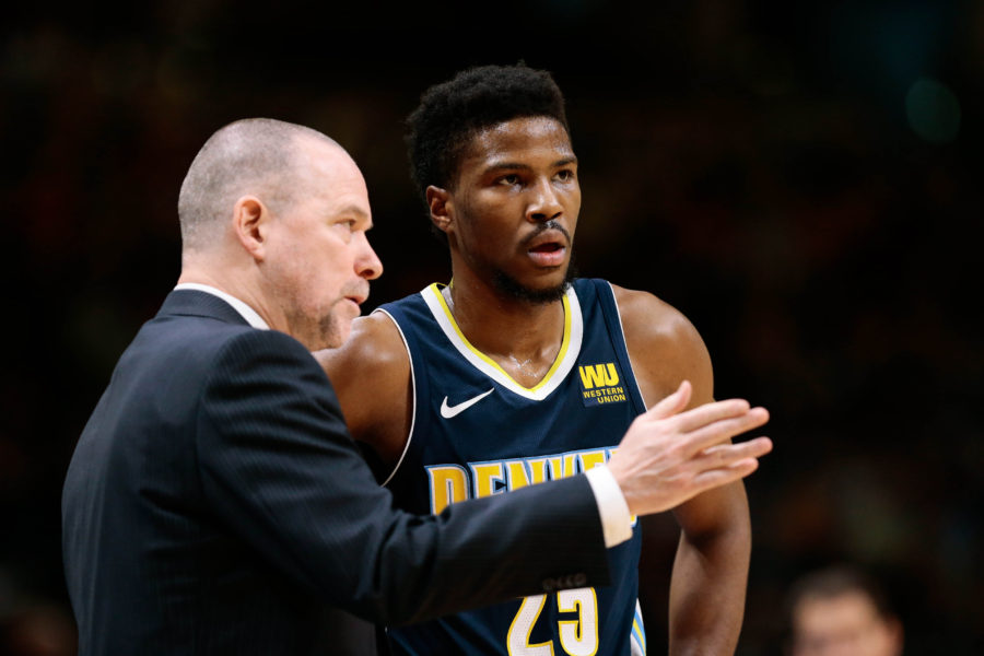 Denver Nuggets head coach Michael Malone talks with guard Malik Beasley (25) in the second quarter against the Memphis Grizzlies at the Pepsi Center.