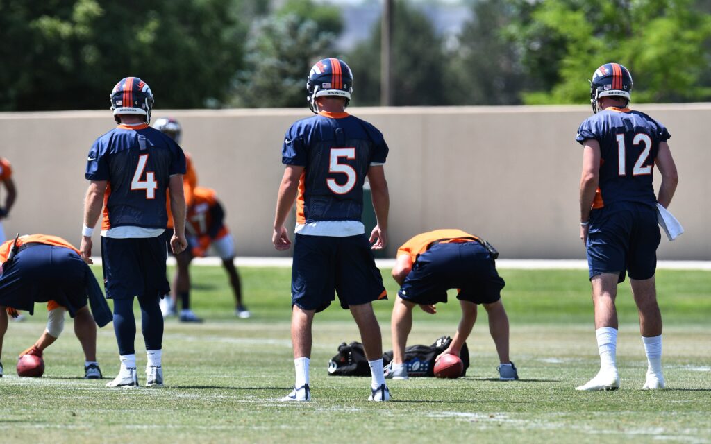 Case Keenum (4) and Paxton Lynch (12) take snaps at Broncos OTAs. Credit: Ron Chenoy, USA TODAY Sports.