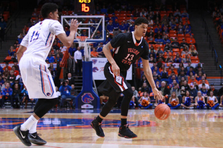 Fresno State Bulldogs forward Cullen Russo (13) dribbles on the perimeter against Boise State Broncos forward Chandler Hutchinson (15) during first half at Taco Bell Arena.