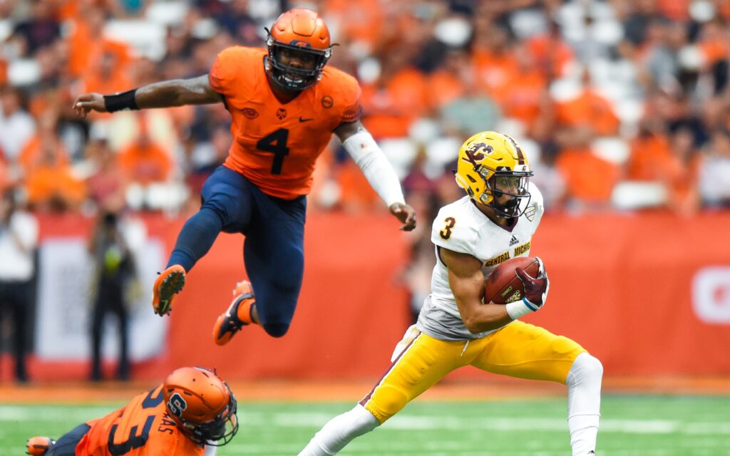 Mark Chapman runs away from defenders. Credit: Rich Barnes, USA TODAY Sports.