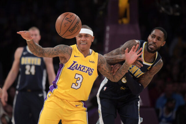 Los Angeles Lakers guard Isaiah Thomas (3) and Denver Nuggets forward Will Barton (5) battle for the ball in the first half during an NBA basketball game at Staples Center. The Lakers defeated the Nuggets 112-103.