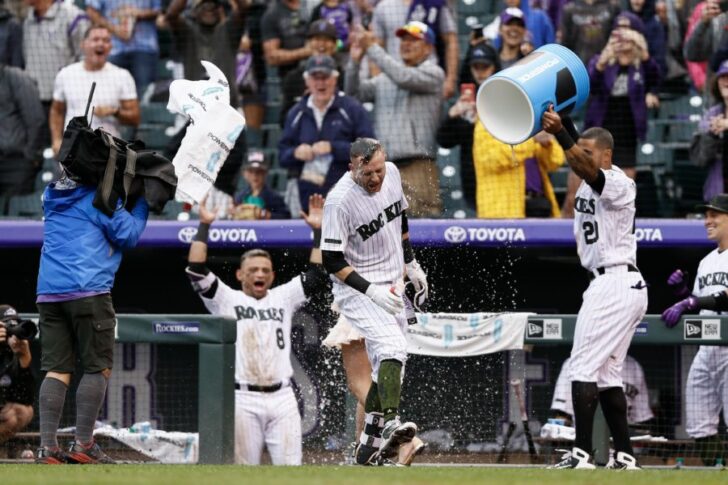 Jul 15, 2018; Denver, CO, USA; Colorado Rockies first baseman Ian Desmond (20) douses shortstop Trevor Story (27) as he is interviewed after a walk off home run in the ninth inning against the Seattle Mariners at Coors Field. Mandatory Credit: Isaiah J. Downing-USA TODAY Sports