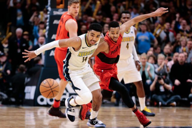 Denver Nuggets guard Gary Harris (14) and Portland Trail Blazers guard CJ McCollum (3) battle for a loose ball in the fourth quarter at the Pepsi Center.