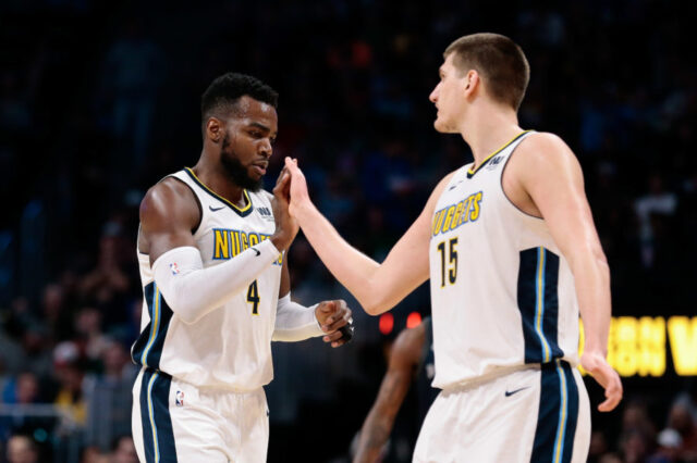 Denver Nuggets forward Paul Millsap (4) reacts with center Nikola Jokic (15) in the third quarter against the Detroit Pistons