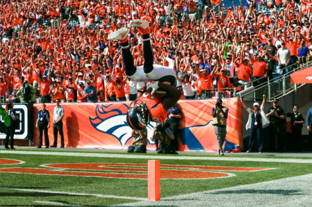 Denver Broncos wide receiver Emmanuel Sanders (10) flips into the end zone after scoring a touchdown in the second quarter against the Seattle Seahawks at Broncos Stadium at Mile High.