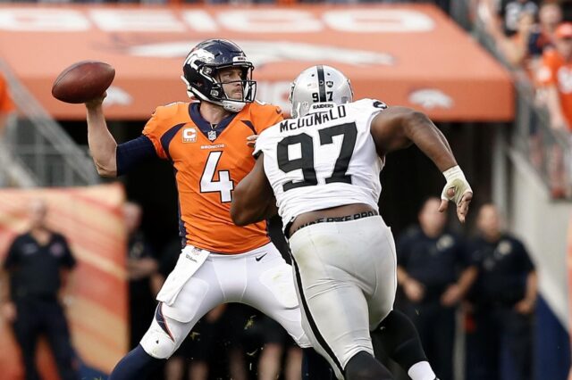 Case Keenum and former Broncos player Clinton McDonald. Credit: Isaiah J. Downing, USA TODAY Sports.