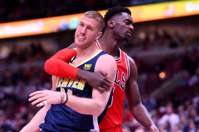 Chicago Bulls forward Bobby Portis (5) fouls Denver Nuggets center Mason Plumlee (24) during the second half at the United Center.