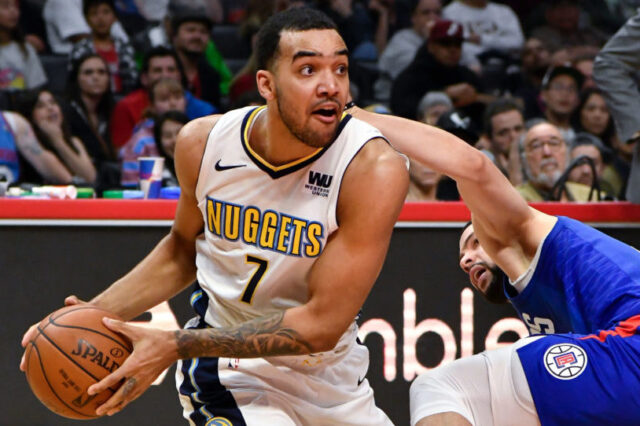 Denver Nuggets forward Trey Lyles (7) and LA Clippers guard Austin Rivers (right) go to the floor for a loose ball during the fourth quarter at Staples Center. The Nuggets went on to a 134-115 win