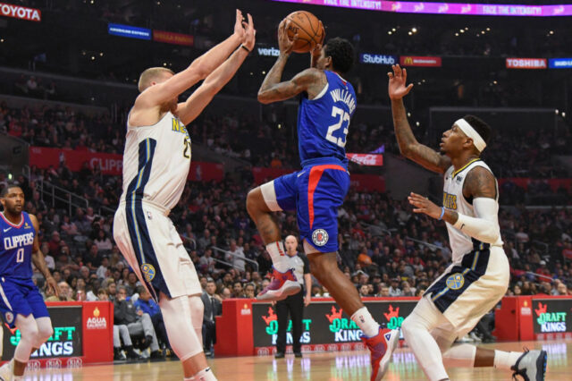 LA Clippers guard Lou Williams (23) drives to the basket between Denver Nuggets center Mason Plumlee (24) and guard Torrey Craig (3) during the first half at Staples Center