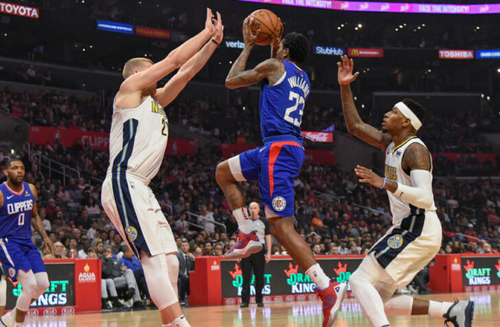 LA Clippers guard Lou Williams (23) drives to the basket between Denver Nuggets center Mason Plumlee (24) and guard Torrey Craig (3) during the first half at Staples Center