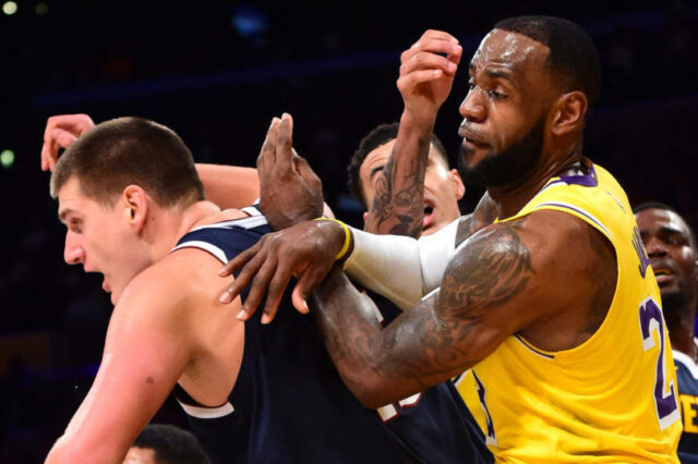 Los Angeles Lakers forward LeBron James (23) battles Denver Nuggets center Nikola Jokic (15) under the basket in the first half at Staples Center.