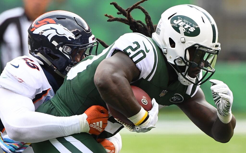 Isaiah Crowell drags Von Miller. Credit: Robert Deutsch, USA TODAY Sports.