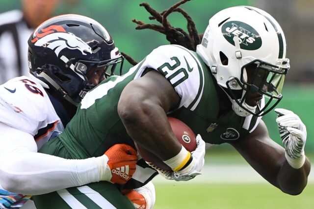 Isaiah Crowell drags Von Miller. Credit: Robert Deutsch, USA TODAY Sports.