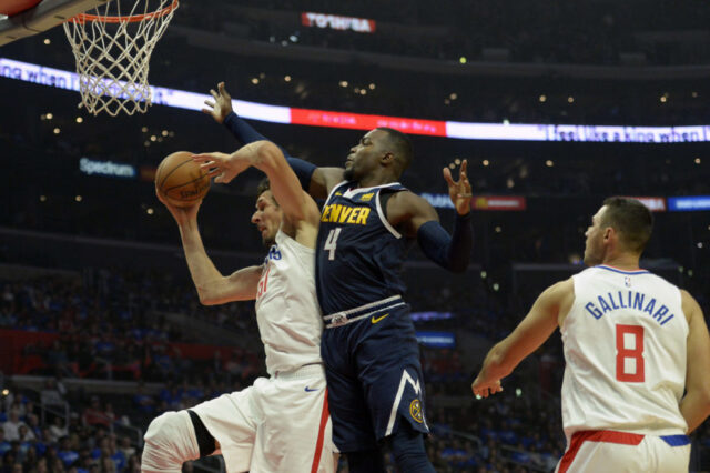 Oct 17, 2018; Los Angeles, CA, USA; LA Clippers center Boban Marjanovic (51) grabs a rebound against Denver Nuggets forward Paul Millsap (4) during the second quarter at Staples Center. Mandatory Credit: Jake Roth-USA TODAY Sports