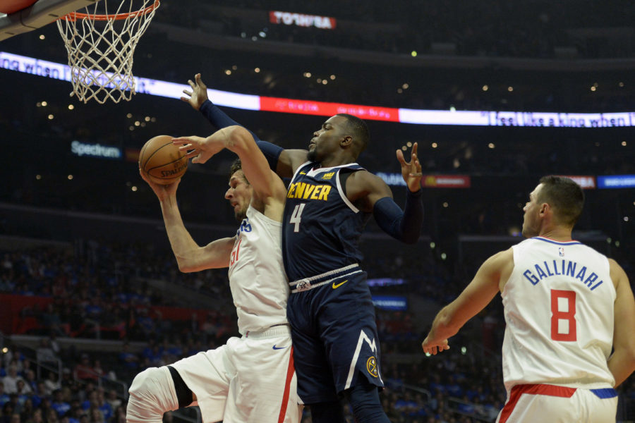 Oct 17, 2018; Los Angeles, CA, USA; LA Clippers center Boban Marjanovic (51) grabs a rebound against Denver Nuggets forward Paul Millsap (4) during the second quarter at Staples Center. Mandatory Credit: Jake Roth-USA TODAY Sports