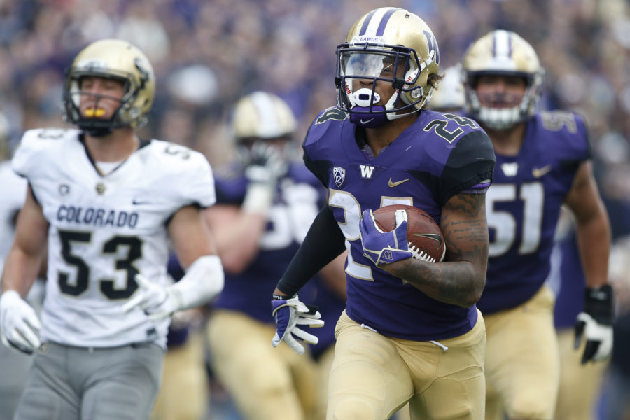 Oct 20, 2018; Seattle, WA, USA; Washington Huskies running back Kamari Pleasant (24) runs for a touchdown ahead of Colorado Buffaloes linebacker Nate Landman (53) during the second quarter at Husky Stadium. Mandatory Credit: Jennifer Buchanan-USA TODAY Sports