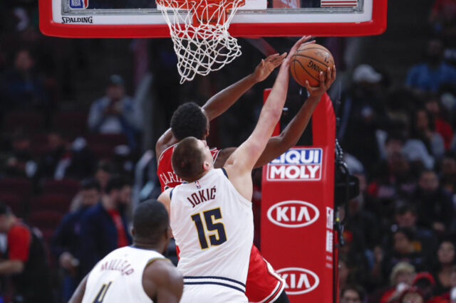 Chicago Bulls forward Wendell Carter Jr. (34) is blocked by Denver Nuggets center Nikola Jokic (15) during the second half at United Center.