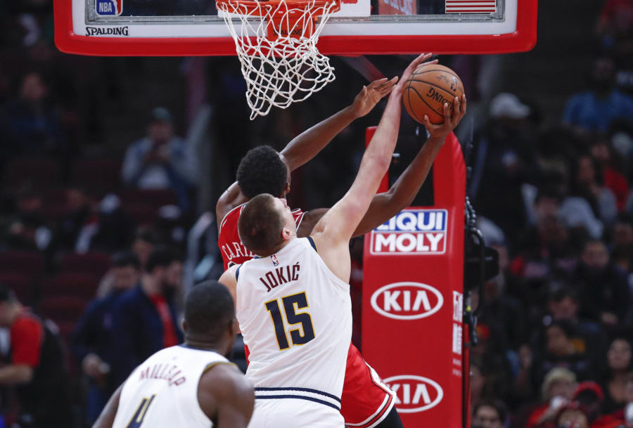 Chicago Bulls forward Wendell Carter Jr. (34) is blocked by Denver Nuggets center Nikola Jokic (15) during the second half at United Center.