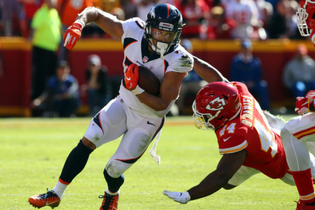 Denver Broncos running back Phillip Lindsay (30) is tackled by Kansas City Chiefs linebacker Dorian O'Daniel (44) in the first half at Arrowhead Stadium