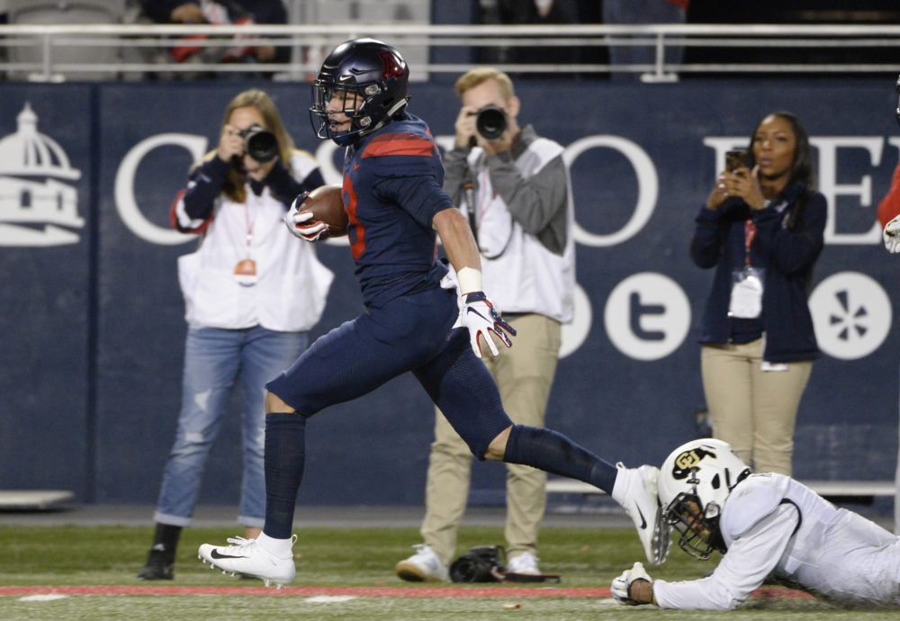 Nov 2, 2018; Tucson, AZ, USA; Arizona Wildcats wide receiver Cedric Peterson (18) runs the ball for a touchdown against Colorado Buffaloes defensive back Derrion Rakestraw (3) during the second half at Arizona Stadium. Mandatory Credit: Casey Sapio-USA TODAY Sports