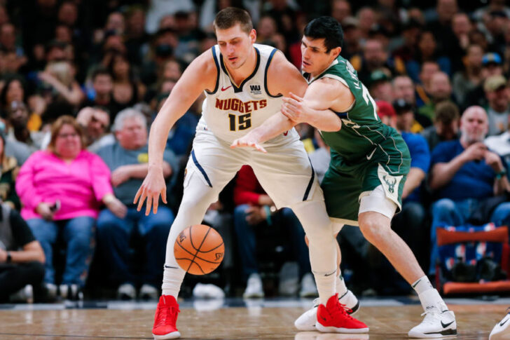 Milwaukee Bucks forward Ersan Ilyasova (77) defends against Denver Nuggets center Nikola Jokic (15) in the second quarter at the Pepsi Center.