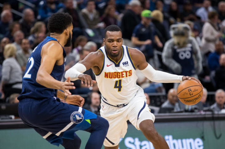 Denver Nuggets forward Paul Millsap (4) dribbles in the first quarter against Minnesota Timberwolves center Karl-Anthony Towns (32) at Target Center.