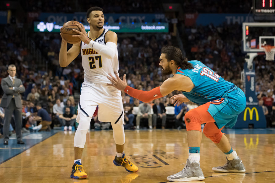 Denver Nuggets guard Jamal Murray (27) looks to pass the ball while defended by Oklahoma City Thunder center Steven Adams (12) during the second quarter at Chesapeake Energy Arena.