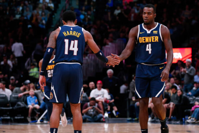 Denver Nuggets guard Gary Harris (14) reacts with forward Paul Millsap (4) after a play in the third quarter against the New Orleans Pelicans at the Pepsi Center.