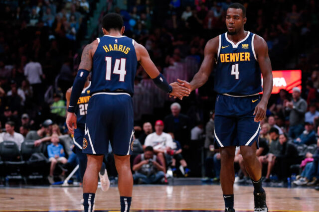 Denver Nuggets guard Gary Harris (14) reacts with forward Paul Millsap (4) after a play in the third quarter against the New Orleans Pelicans at the Pepsi Center.