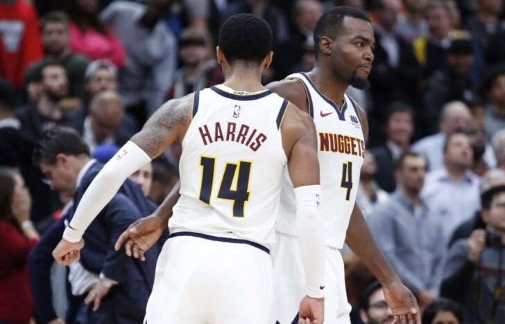 Denver Nuggets forward Paul Millsap (4) is congratulated by guard Gary Harris (14) after scoring game winning points in overtime against the Chicago Bulls at United Center.