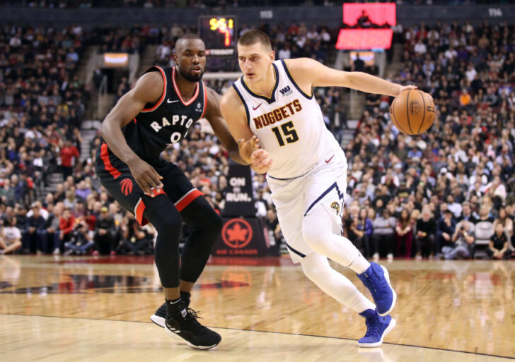 Denver Nuggets center Nikola Jokic (15) drives past Toronto Raptors forward Serge Ibaka (9) in the second quarter at Scotiabank Arena.