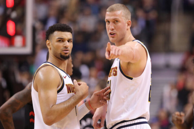 Denver Nuggets forward Mason Plumlee (24) talks to guard Jamal Murray (27) against the Toronto Raptors at Scotiabank Arena. The Nuggets beat the Raptors 106-103.