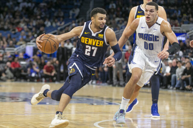 Denver Nuggets guard Jamal Murray (27) drives past Orlando Magic forward Aaron Gordon (00) during the second half at Amway Center.