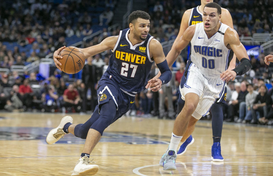 Denver Nuggets guard Jamal Murray (27) drives past Orlando Magic forward Aaron Gordon (00) during the second half at Amway Center.