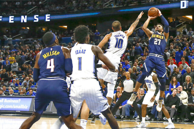 Dec 5, 2018; Orlando, FL, USA; Denver Nuggets guard Jamal Murray (27) shoots over Orlando Magic guard Evan Fournier (10) as Magic forward Jonathan Isaac (1) and Nuggets forward Paul Millsap (4) look on during the second half at Amway Center. Mandatory Credit: Reinhold Matay-USA TODAY Sports