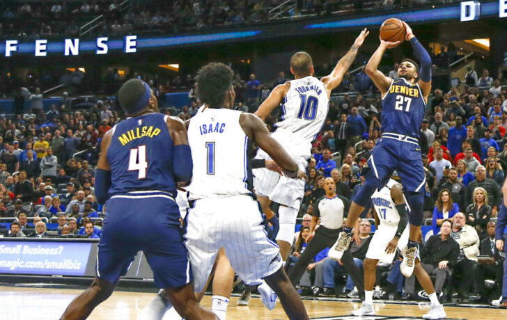 Dec 5, 2018; Orlando, FL, USA; Denver Nuggets guard Jamal Murray (27) shoots over Orlando Magic guard Evan Fournier (10) as Magic forward Jonathan Isaac (1) and Nuggets forward Paul Millsap (4) look on during the second half at Amway Center. Mandatory Credit: Reinhold Matay-USA TODAY Sports