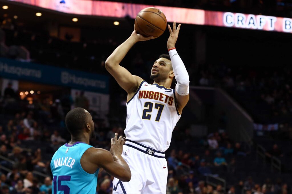 Denver Nuggets guard Jamal Murray (27) shoots the ball over Charlotte Hornets guard Kemba Walker (15) in the first half at Spectrum Center.