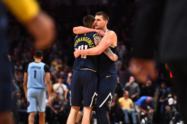 Denver Nuggets center Nikola Jokic (15) and forward Juan Hernangomez (41) celebrate the win over the Memphis Grizzlies at the Pepsi Center.