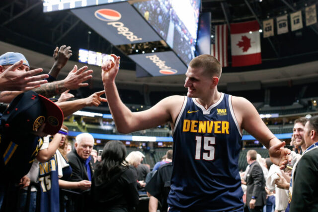 Denver Nuggets center Nikola Jokic (15) celebrates coming off the court after the game against the Dallas Mavericks at the Pepsi Center.