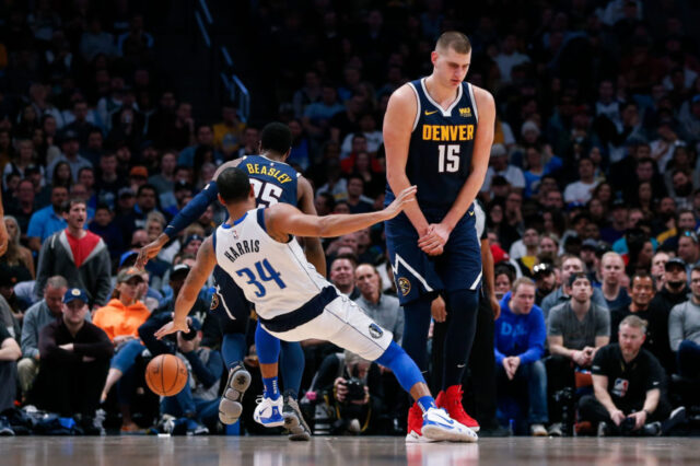 Dallas Mavericks guard Devin Harris (34) falls to the court as Denver Nuggets center Nikola Jokic (15) screens for guard Malik Beasley (25) in the fourth quarter at the Pepsi Center.