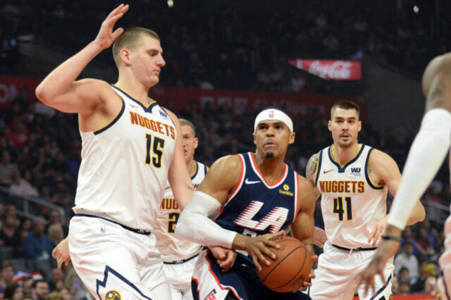 Los Angeles Clippers forward Tobias Harris (34) moves to the basket against Denver Nuggets center Nikola Jokic (15) during the first half at Staples Center.