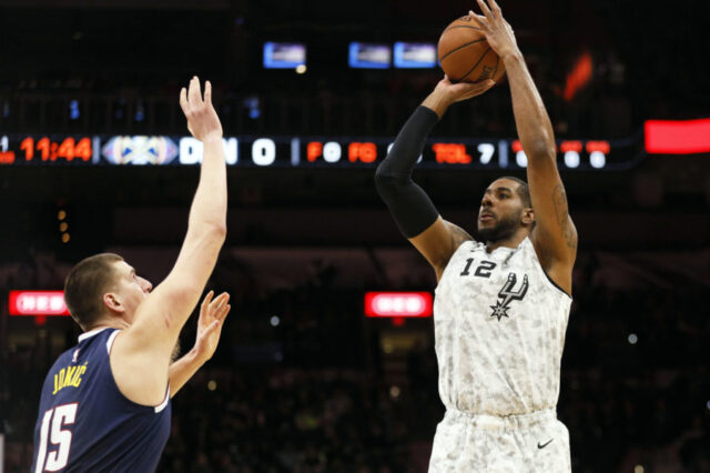 San Antonio Spurs power forward LaMarcus Aldridge (12) shoots the ball over Denver Nuggets center Nikola Jokic (15) during the first half at AT&T Center.