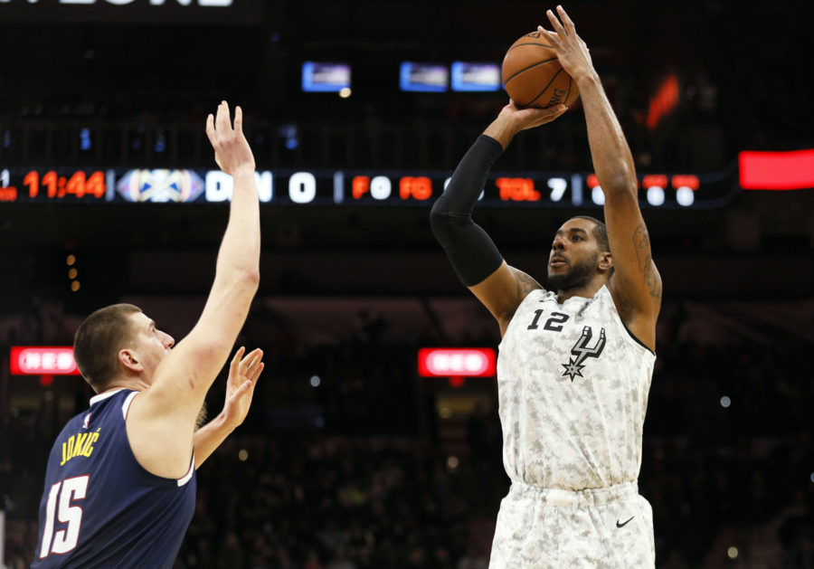 San Antonio Spurs power forward LaMarcus Aldridge (12) shoots the ball over Denver Nuggets center Nikola Jokic (15) during the first half at AT&T Center.