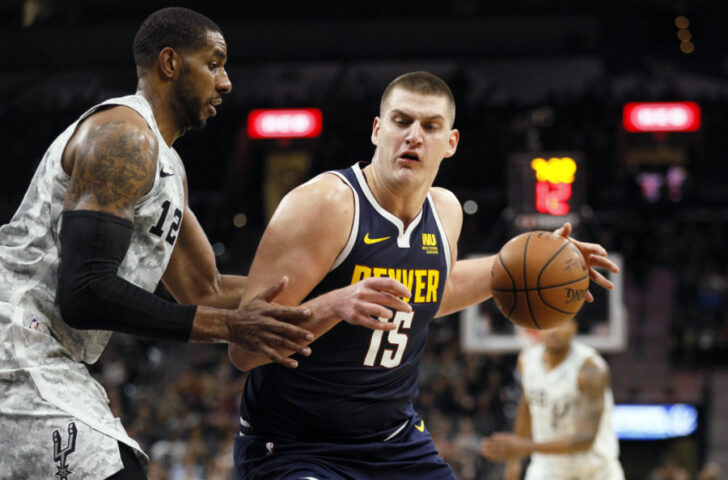 Denver Nuggets center Nikola Jokic (15) posts up against San Antonio Spurs power forward LaMarcus Aldridge (12) during the second half at AT&T Center.