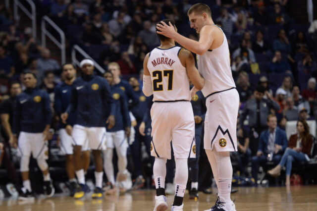 Denver Nuggets center Nikola Jokic (15) celebrates with Denver Nuggets guard Jamal Murray (27) during the second half against the Phoenix Suns at Talking Stick Resort Arena.