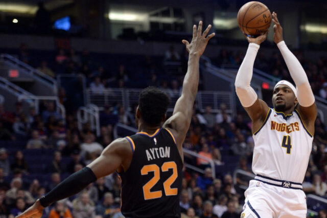 Denver Nuggets forward Paul Millsap (4) shoots over Phoenix Suns center Deandre Ayton (22) during the second half at Talking Stick Resort Arena.